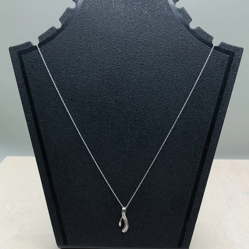 Solid 10k white gold multi baguette diamond wishbone pendant necklace.